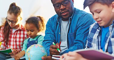 Teacher helping students